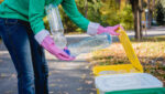 Volunteer girl sorts garbage in the street of the park